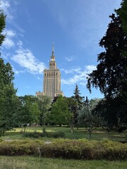 View of 1950s Gothic style tower seen through a green park