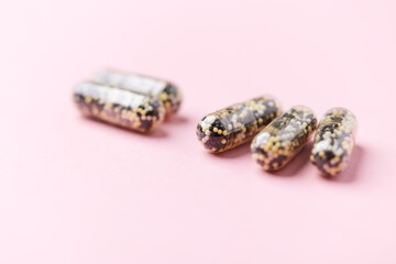 Iron capsules on bright background. Soft focus. Close up. Copy space.	
