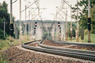 Curved railway tracks extending into the distance, both rails clearly visible, forming a dynamic perspective. A clean composition capturing movement and direction
