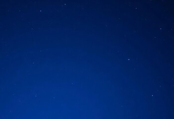Obraz premium Deep blue gradient sky speckled with vibrant blue stars, dark blue background, sky
