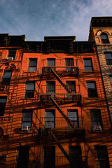old brick building with fire escapes 