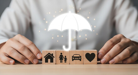 Hands protecting wooden blocks with umbrella icon representing insurance coverage for home family car and health symbolizing safety security and financial protection

