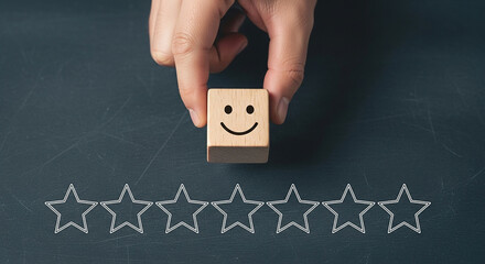 Hand placing wooden block with smiley face above star rating scale on dark background symbolizing customer feedback evaluation review and satisfaction level

