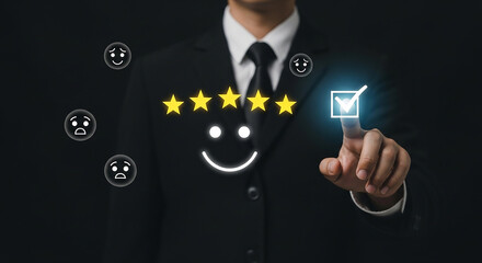 Businessman giving five star rating with smiley face and checkmark on virtual screen representing customer satisfaction and positive feedback review

