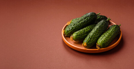 Fresh raw whole cucumbers, an ingredient for preparing salads and vegetarian dishes. Green fresh cucumbers