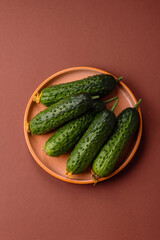 Fresh raw whole cucumbers, an ingredient for preparing salads and vegetarian dishes. Green fresh cucumbers