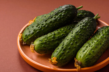 Fresh raw whole cucumbers, an ingredient for preparing salads and vegetarian dishes. Green fresh cucumbers