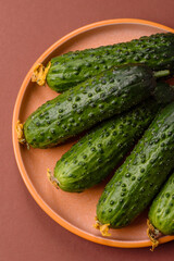 Fresh raw whole cucumbers, an ingredient for preparing salads and vegetarian dishes. Green fresh cucumbers
