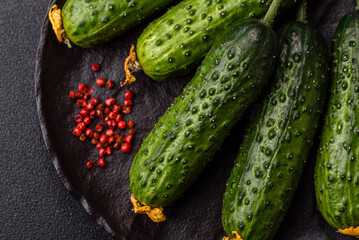Fresh raw whole cucumbers, an ingredient for preparing salads and vegetarian dishes. Green fresh...