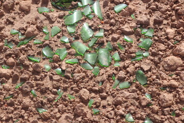 Green glass shards on the ground