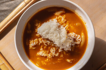 overhead shot of a curry soup with rice