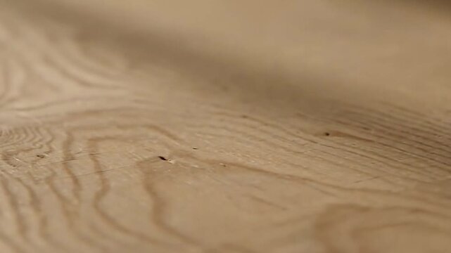 Warm wooden texture. A close-up photograph showcasing the beautiful and intricate grain patterns of a light wood surface.