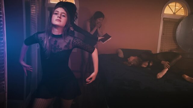 Gothic woman dances while exorcism performed in background