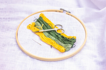 hoops, threads, scissors and white fabric, the embroidery kit. hobby, craft, leisure.