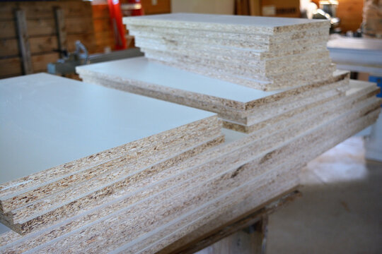 Stack of Particle Board Panels in a Workshop
