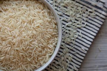 Uncooked White Organic Basmati Rice in a Bowl, top view. Close-up.