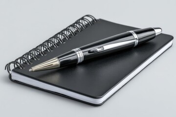 Notebook and Pen Resting on a Clean White Background for Note-Taking and Homework