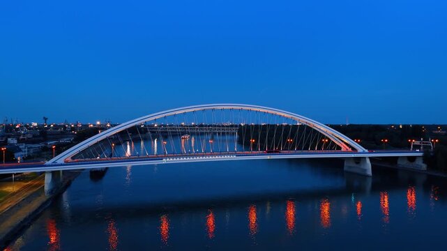 Dusk time in Bratislava, Slovakia. Footage over the Danube near the Appolo Bridge with street lights on.