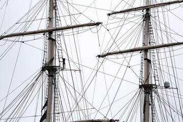 Fototapeta premium Masts and Rigging of a Tall Ship Against a Sky