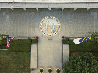 Aerial view of the North Carolina State legislature building with the state seal at the entrance