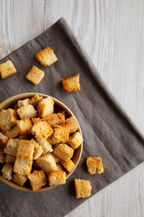 Homemade Crispy Bread Croutons in a Bowl, top view. Space for text.