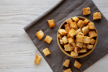 Homemade Crispy Bread Croutons in a Bowl, top view. Copy space.