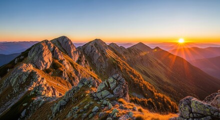 Majestic mountain peaks bathed in the warm glow of a vibrant sunrise