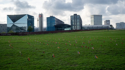 Berlin, Germany - July 25, 2025: Hundreds of rainbow color LGBTQ pride flags in green grass between Bundestag and central station