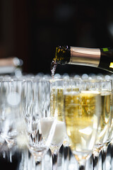 Champagne being poured into elegant flutes
