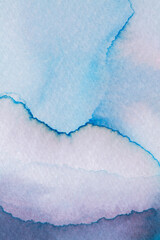 Ink on paper displays soft gradients of blue and violet hues in an artistic design