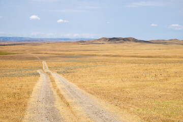 Obraz premium Wide View of Harvested Fields With Rolling Hills