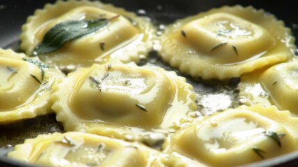 Delicious ravioli pasta recipe cooking in pan with butter and sage for gourmet food lovers video 4k - Powered by Adobe