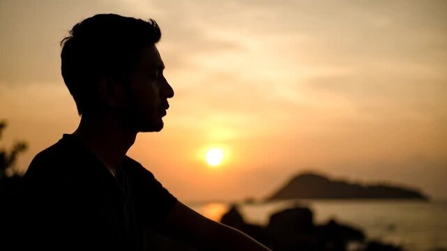Melancholy Sunset Silhouette: Man's Sadness at Dusk