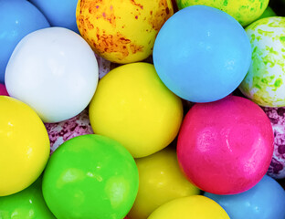 colorful various round candy yellow blue bright dessert in a wooden bowl close-up