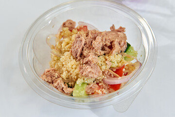 Nutritious Bowl of Couscous Salad with Fresh Vegetables and Tuna, Perfect for a Healthy Meal or Quick Snack Option Rich in Flavor and Texture