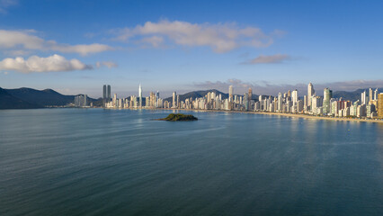 Naklejka premium Morning aerial view of Balneário Camboriú skyline and beach with calm ocean and blue sky.
