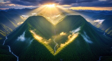 Sunbeams pierce through dramatic clouds over a heartshaped mountain valley