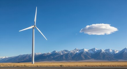 A solitary wind turbine stands tall against a clear blue sky with distant snowcapped mountains