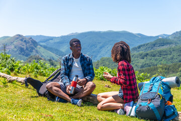 Hikers resting and enjoying refreshments in mountain scenery
