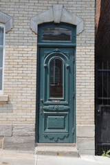 Old wooden door with pattern and turquoise color. Ancient outdoor entrance in a old city. 