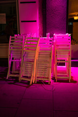 Vibrant Outdoor Chairs Stacked at Night in Hamburg, Germany