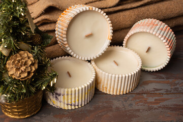 A gift for the New year 2023. A set of different aroma candles. Scented handmade candle on a wooden background. Soy candles Aromatherapy and relax in spa and home. Still life.