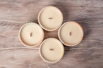 A set of different aroma candles. Flat lay. Scented handmade candle on a wooden background. Soy candles Aromatherapy and relax in spa and home. Still life.