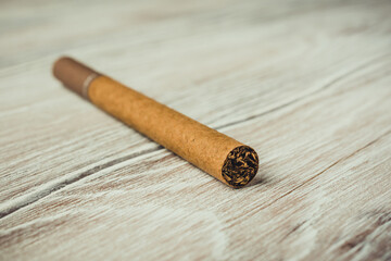 Cigarette on the wooden background. Tobacco smoking. Tobacco or health. 