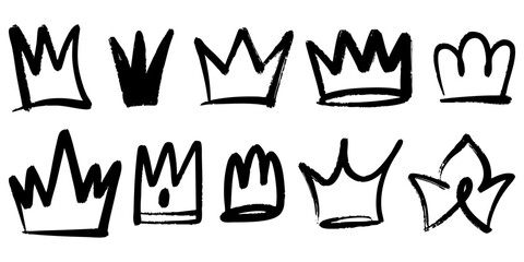 Set of hand drawn crown doodles in black ink on white background. Unique grunge style sketch icons representing royalty, power, leadership, and creativity.