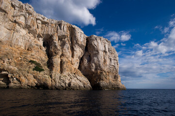 Punta Giglio promontory from the sea. Alghero, SS, Sardinia, Italy