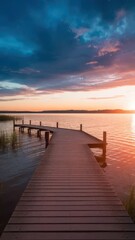 Fototapeta premium A captivating sunset illuminating the tranquil lake with a wooden pathway