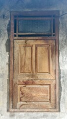 Rustic Wooden Window on Weathered Concrete Wall, Timeworn Window Frame and Patterned Glass Above