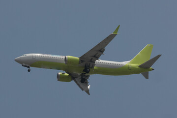 Airplane Descending Toward Runway During Summer Afternoon