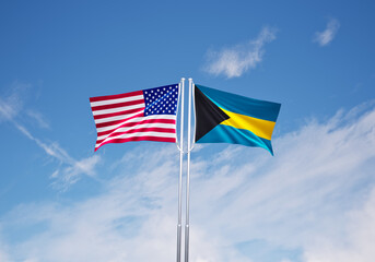 flags of  bahamas and United States of America over blue sky background.
